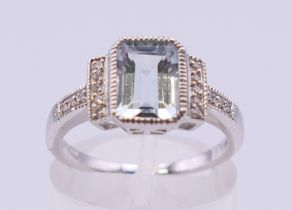An 18 ct white gold rectangular aquamarine and diamond ring. Ring size L/M. 3.