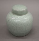 A Celadon glazed lidded ginger jar, with square seal mark to base. 15 cm high.