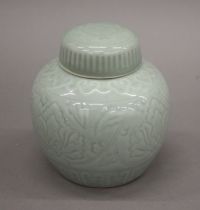 A Celadon glazed lidded ginger jar, with square seal mark to base. 15 cm high.