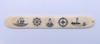 A scrimshaw bone page turner. 17.5 cm long.