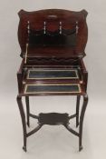 An Edwardian mahogany folding ladies writing table. 56.5 cm wide.