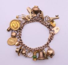 A 9 ct gold charm bracelet with a 1902 half sovereign. 18 cm long. 51.3 grammes total weight.