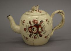 An 18th century Creamware bullet form teapot, possibly Leeds. 13 cm high.