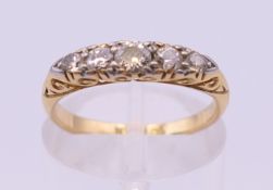 An 18 ct gold five stone diamond ring. Ring size K/L. 2.9 grammes total weight.
