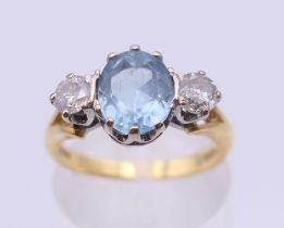 An 18 ct gold diamond and aquamarine ring. Ring size L/M. 4.3 grammes total weight.