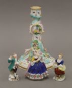 A Meissen porcelain candlestick and three Continental porcelain figures. The former 16 cm high.