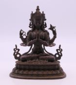 A small bronze model of a multi-armed deity. 10.5 cm high.