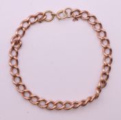 A 9 ct rose gold bracelet with associated clasp and link. 20 cm long. 15.6 grammes.