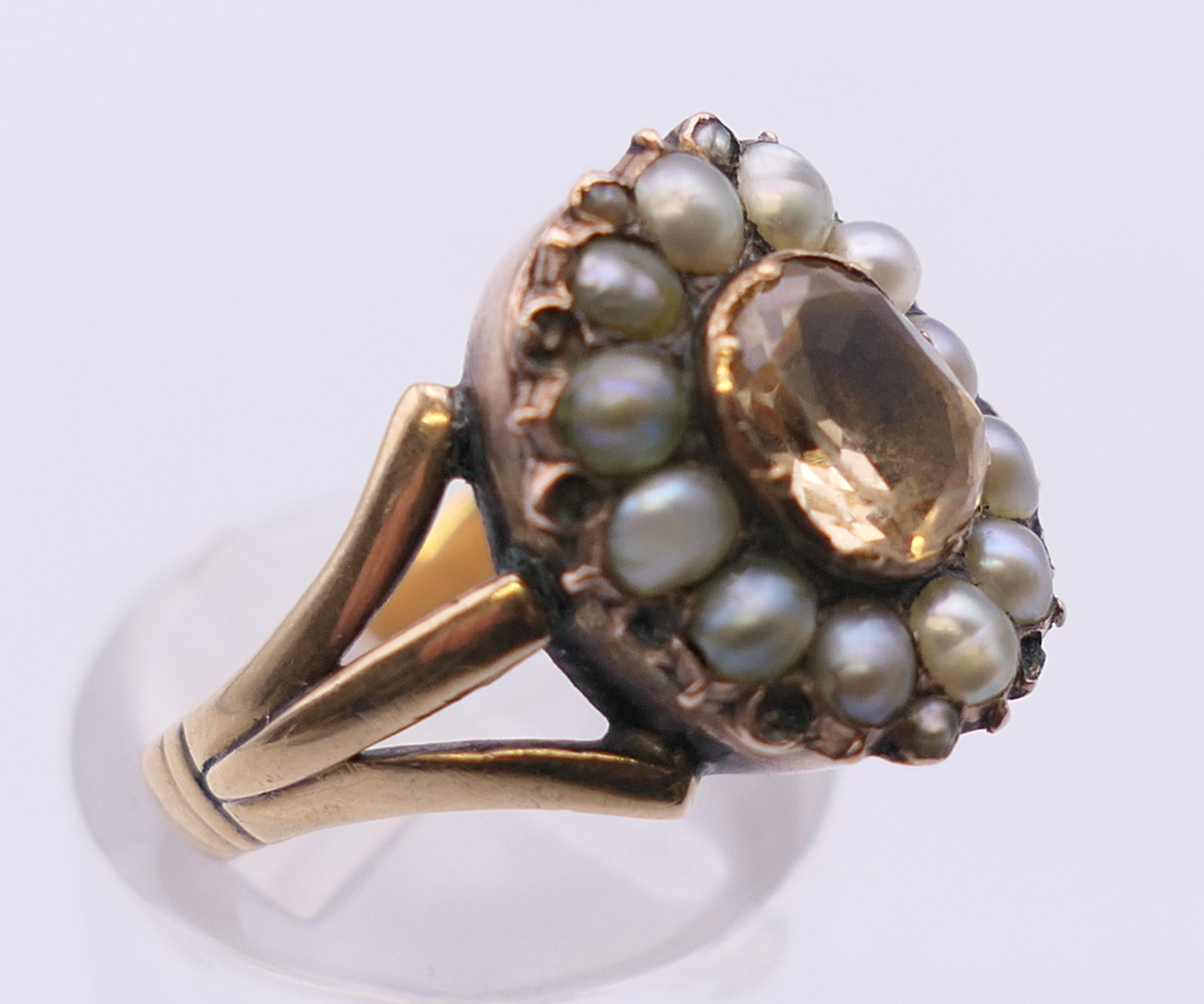 An antique unmarked gold Imperial topaz and seed pearl ring. Ring size N/O. 5. - Image 2 of 5