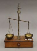 A set of brass and mahogany apothecary scales. 31.5 cm wide.