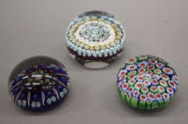 Three vintage glass paperweights. The largest 7 cm high.