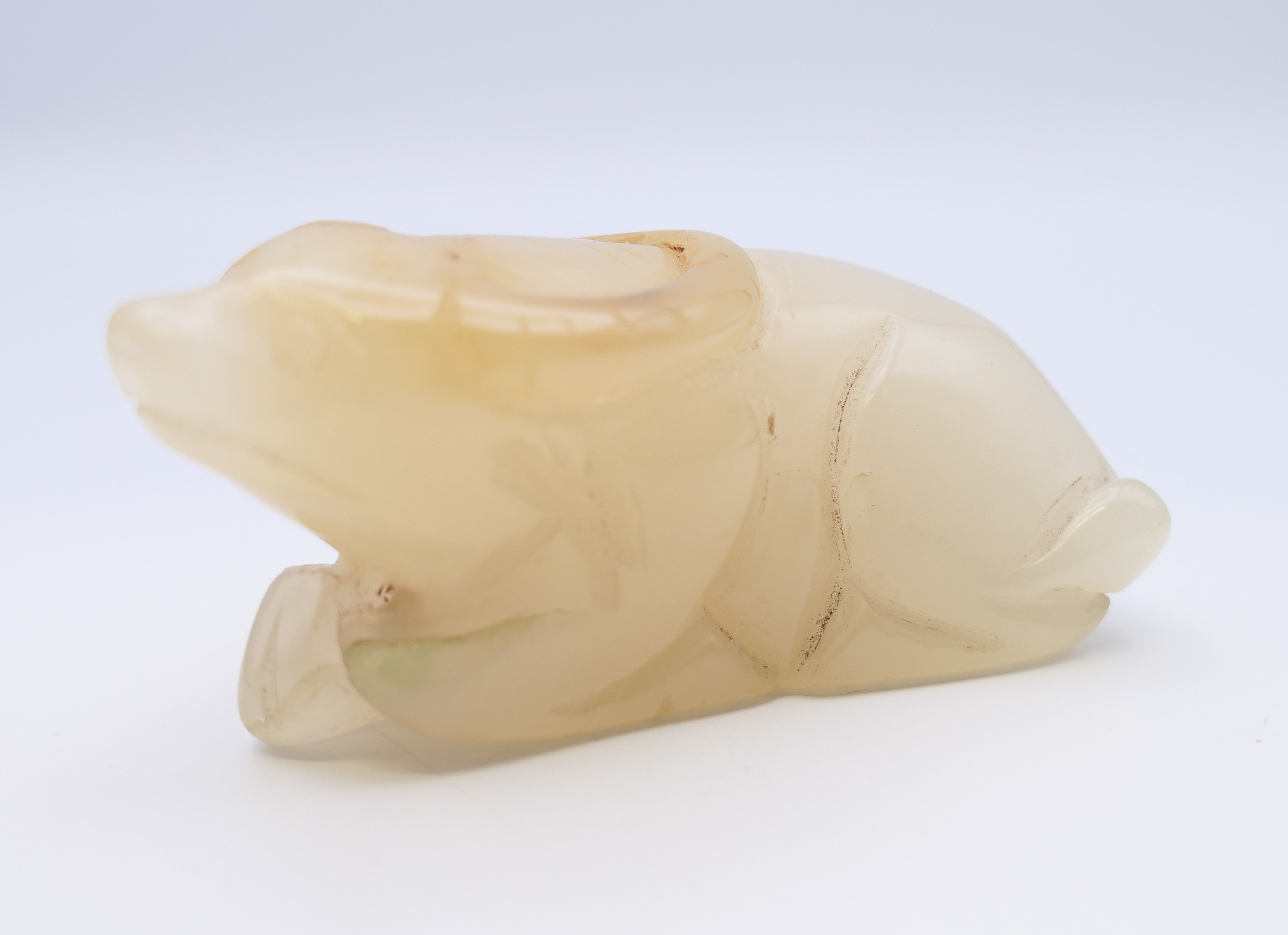 A Chinese white jade recumbent water buffalo, late Qing Dynasty or after. 7 cm long.