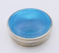 An American enamel decorated sterling silver box. 6.5 cm diameter.