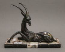 An Art Deco silvered model of an antelope on a marble base. 27 cm long.