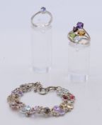 A silver gem set bracelet and two rings. Bracelet 18 cm long.