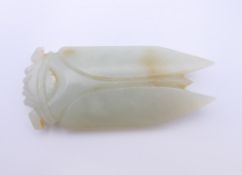 A Chinese light green jade cicada, Han Dynasty. 7 cm long. Provenance: The Larkin/Minney Collection.