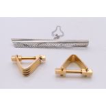 A pair of 18 ct gold cufflinks (11.7 grammes) and an 18 ct white gold tie clip (7.3 grammes).