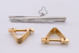 A pair of 18 ct gold cufflinks (11.7 grammes) and an 18 ct white gold tie clip (7.3 grammes).