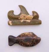 A Chinese hardstone carved fish form pendant and a jade brush rest.