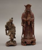 Two carved wooden Oriental figures. The largest 26.5 cm high.