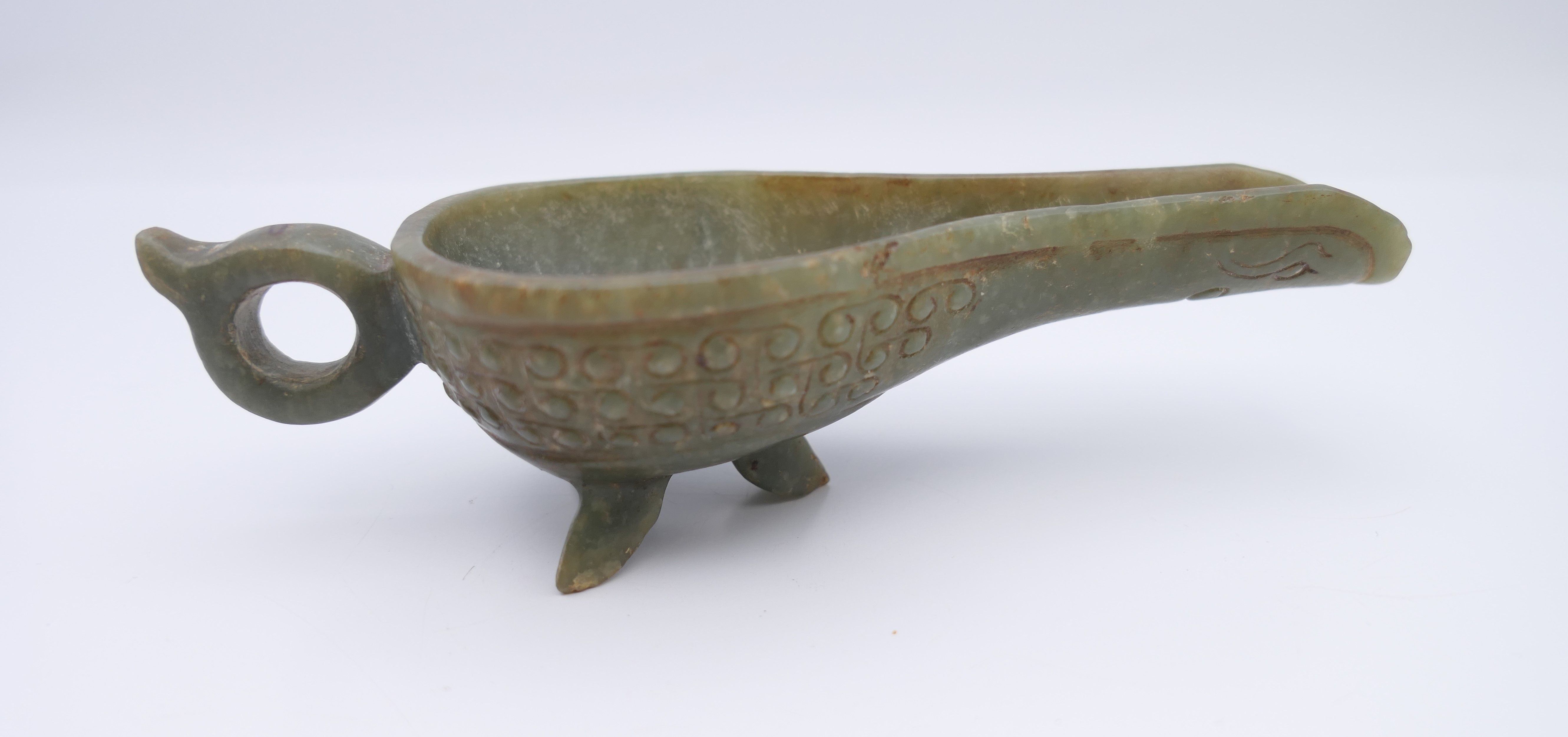 A Chinese green jade ceremonial wine cup, Eastern Han. 14 cm long.