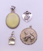 Four silver pendants. The largest 4 cm high. 50.5 grammes total weight.