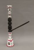 An Ottoman carved wooden and porcelain hookah pipe, circa 1900. 70.5 cm high.