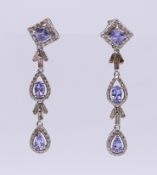 A pair of diamond and blue tanzanite earrings. 4 cm high.