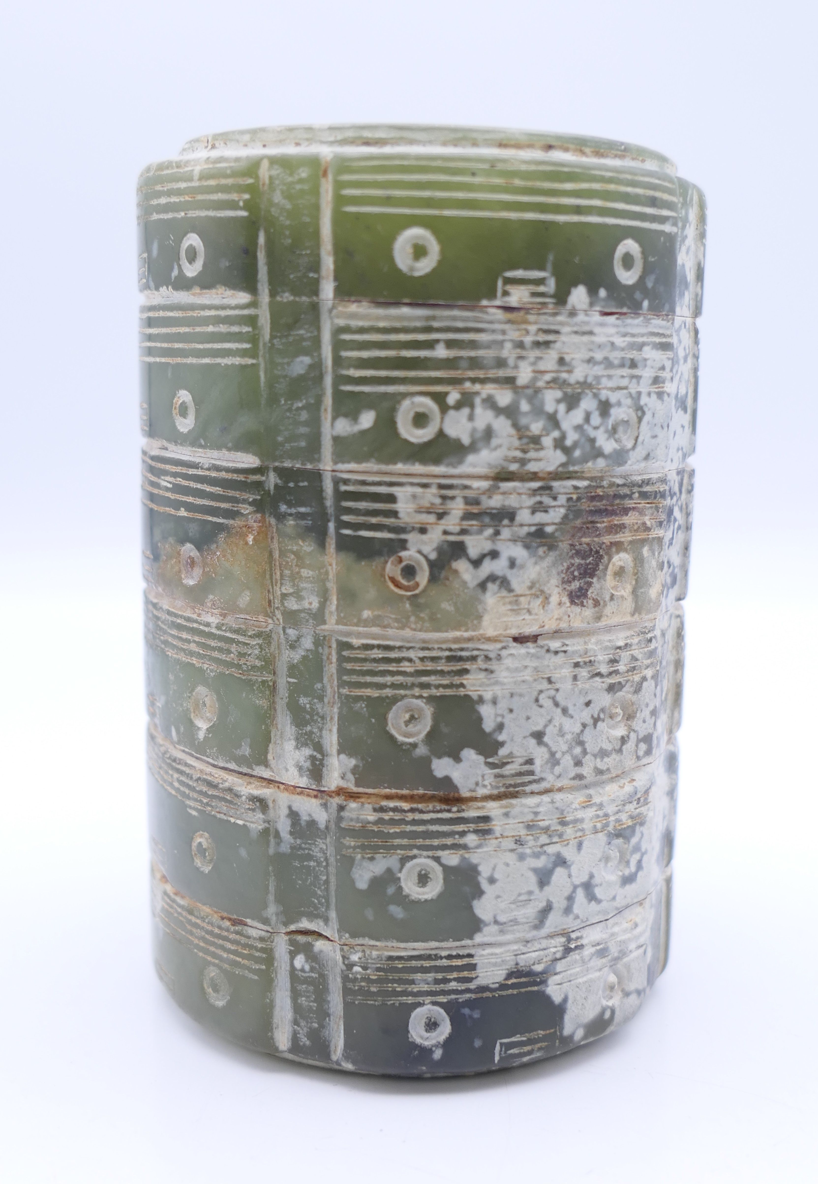 A Chinese green jade round sectional cong glued together, possibly with pine sap. 8 cm high.