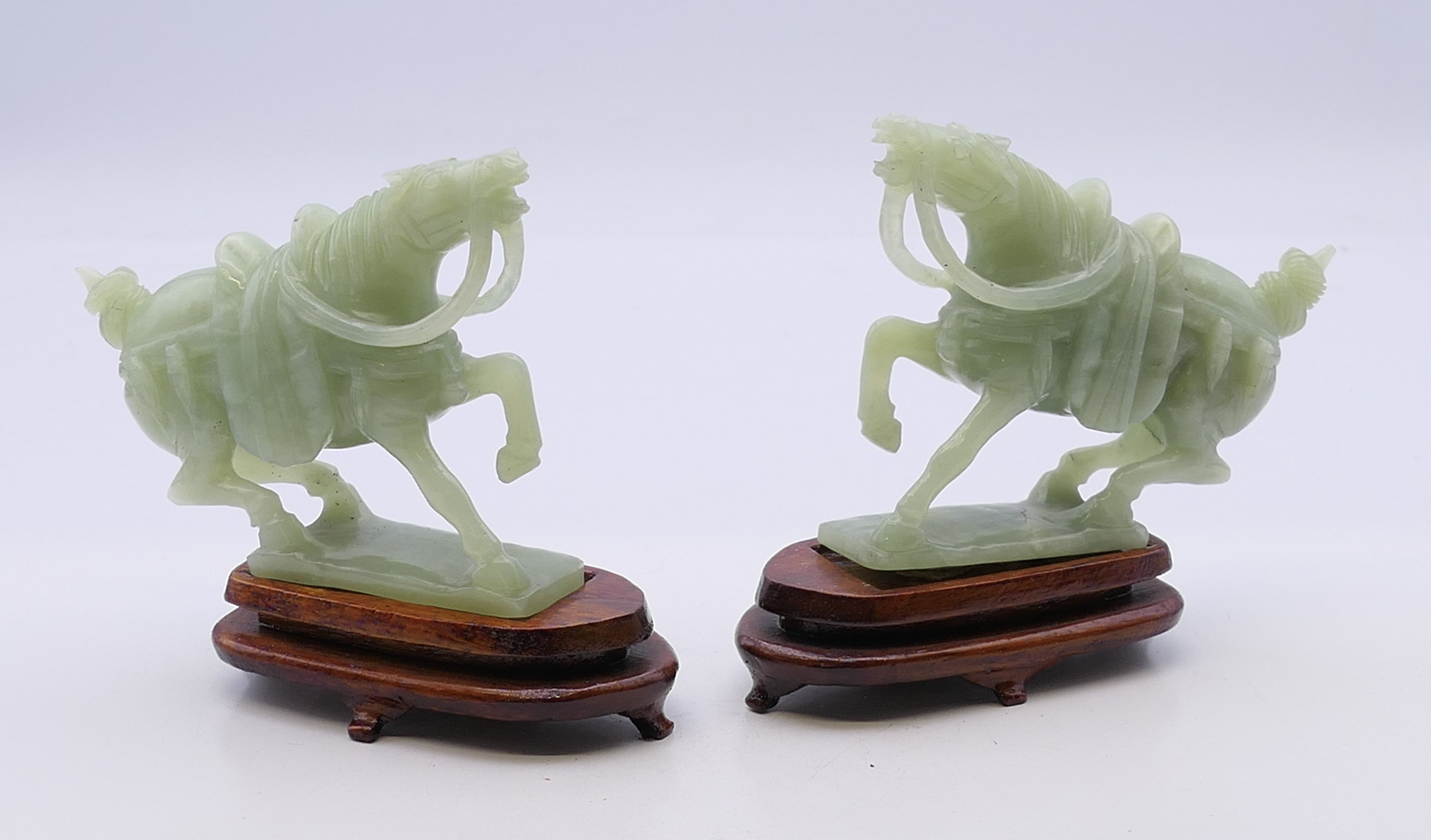 A pair of jade horses on wooden stands. Each 10 cm high including stand.