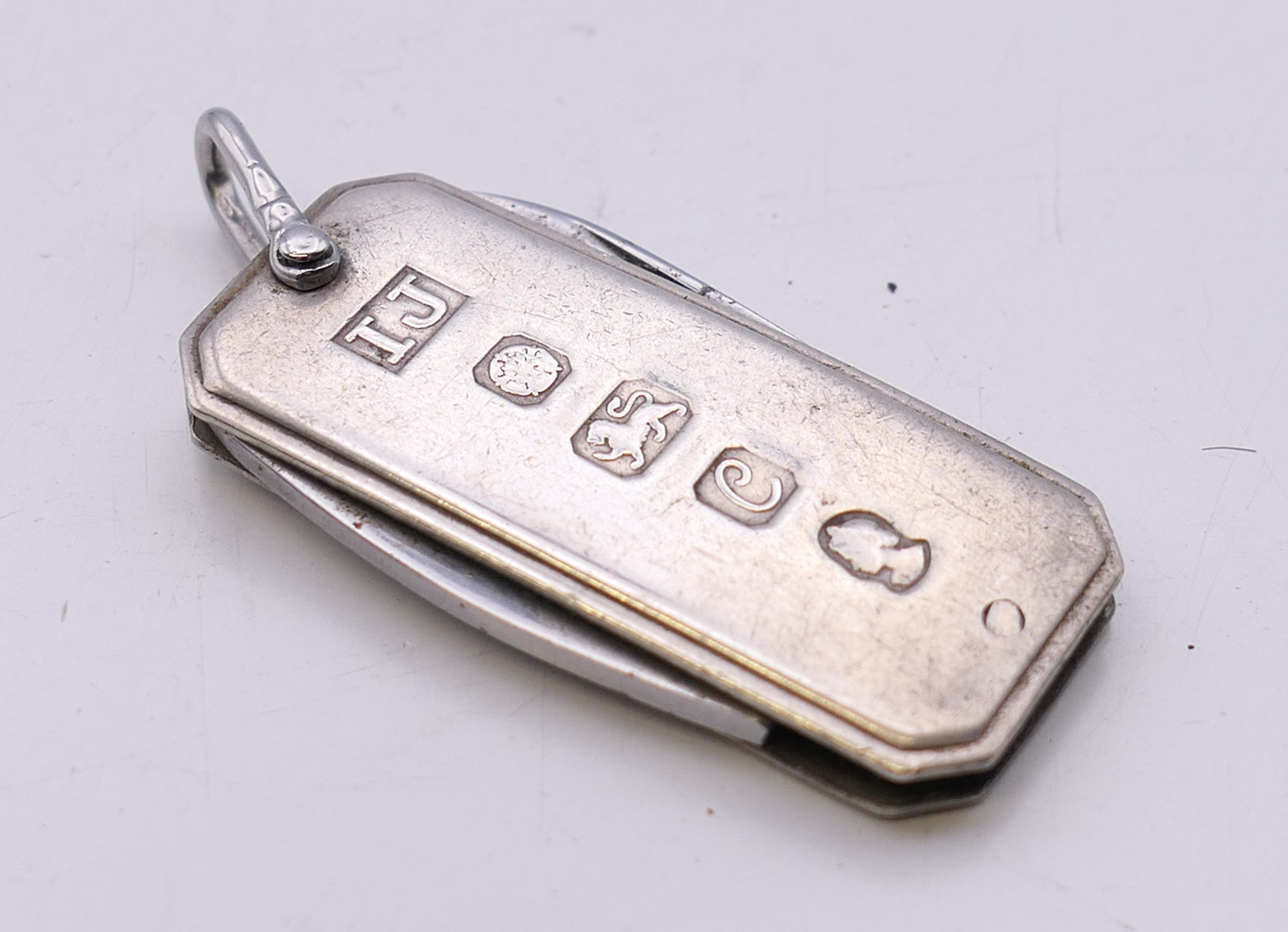 A silver cased penknife. 4.5 cm x 2 cm. 26 grammes total weight.