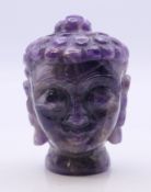 A carved amethyst bust of Buddha. 7 cm high.