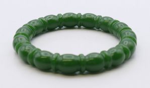 A shaped jade bangle. 5.75 cm internal diameter.
