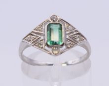 A platinum, diamond and emerald Art Deco style ring. Ring size N/O. 3.8 grammes total weight.