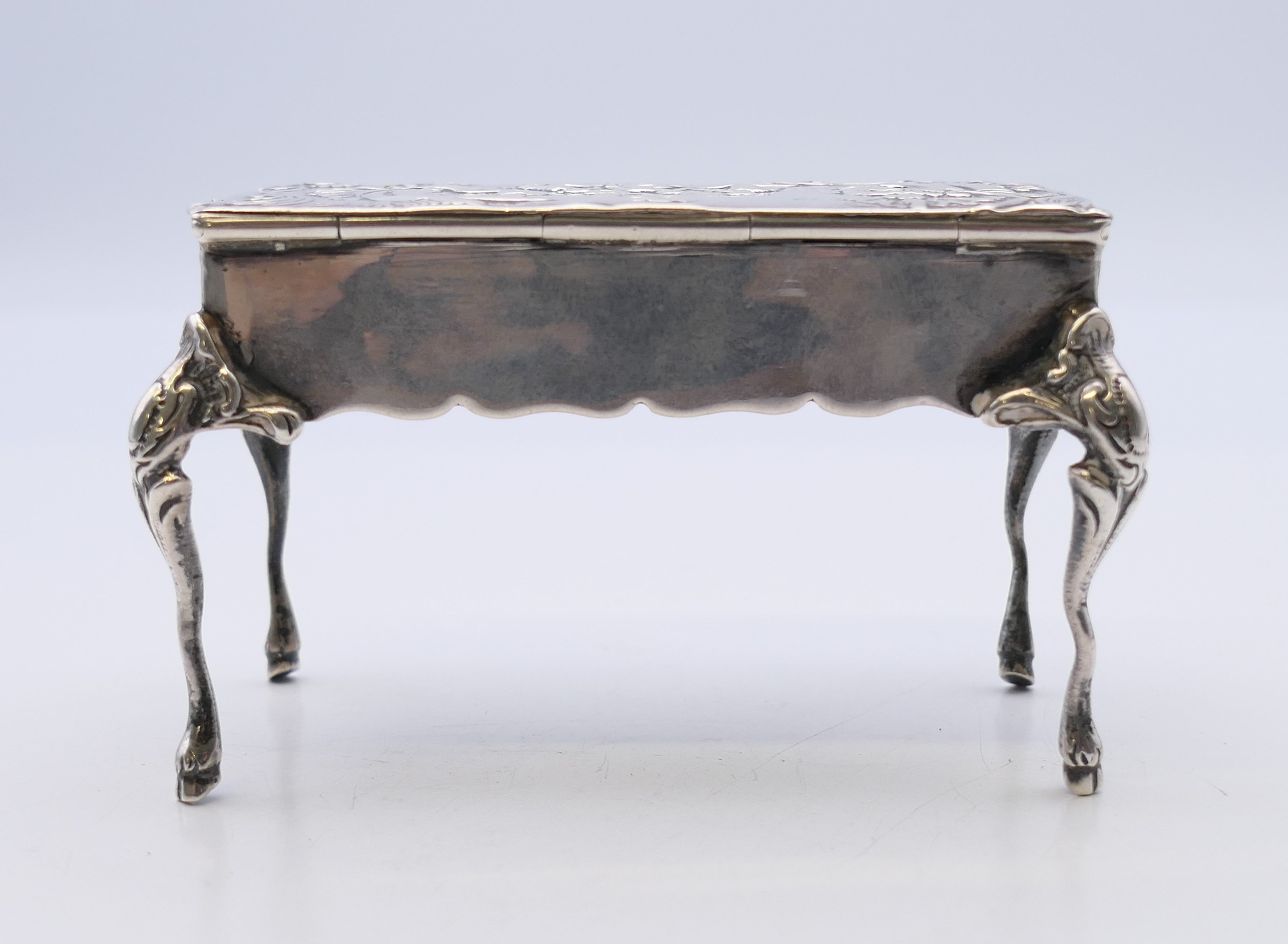 An embossed silver trinket box formed as a table, import marks for London 1899. - Image 5 of 11