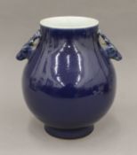 A Chinese porcelain dark blue ground ovoid vase with stag head handles. 23 cm high.