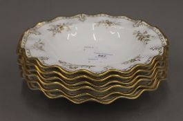 Six Royal Crown Derby gilt decorated bowls. 22 cm diameter.