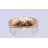 An 18 ct gold gypsy set diamond ring. Ring size O. 2 grammes total weight.