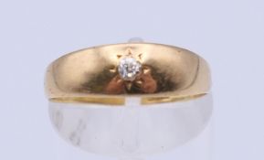An 18 ct gold gypsy set diamond ring. Ring size O. 2 grammes total weight.