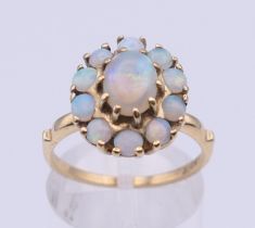 A 10 ct gold opal cluster ring. Ring size M/N. 3.6 grammes total weight.