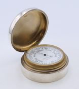 A Mappin and Webb silver cased barometer. 6 cm diameter.