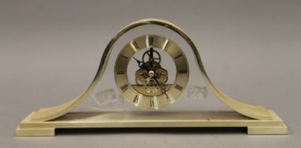 A brushed metal mantle clock. 30 cm wide.