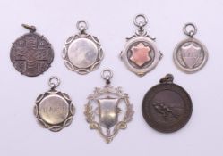 A small quantity of various silver and other fobs, and a Life Savers medallion.