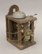 A Victorian postman's alarm clock movement. 23 cm high.