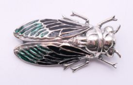 A silver enamel insect form brooch. 5 cm long.