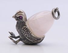 A silver jade egg and chick shaped pendant. 3 cm high.