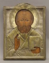 A 19th century Russian icon of St Nicholas painted on wooden panel, covered in a metal oclad. 24.