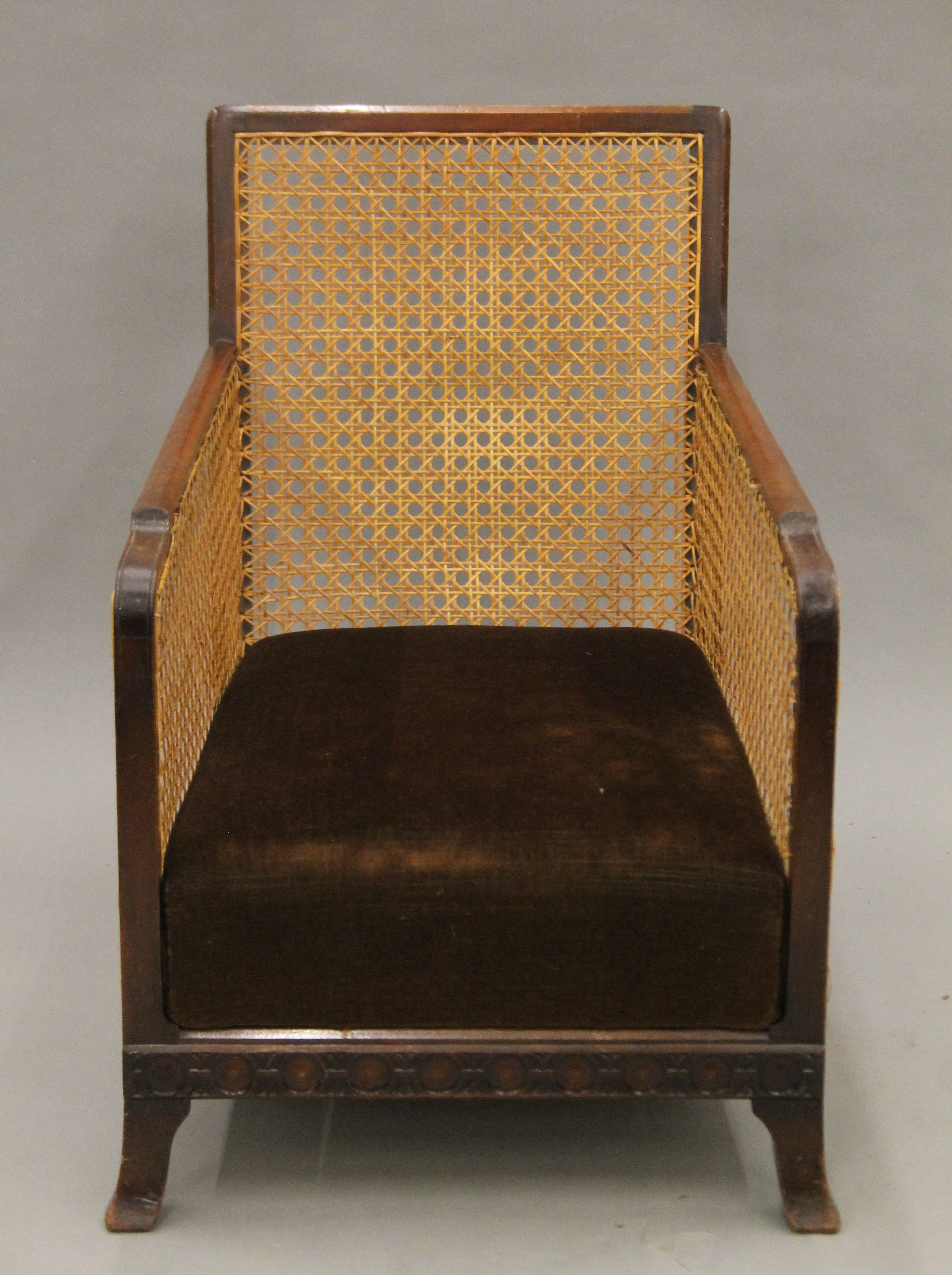 An early 20th century mahogany framed Bergere armchair. 54 cm wide.