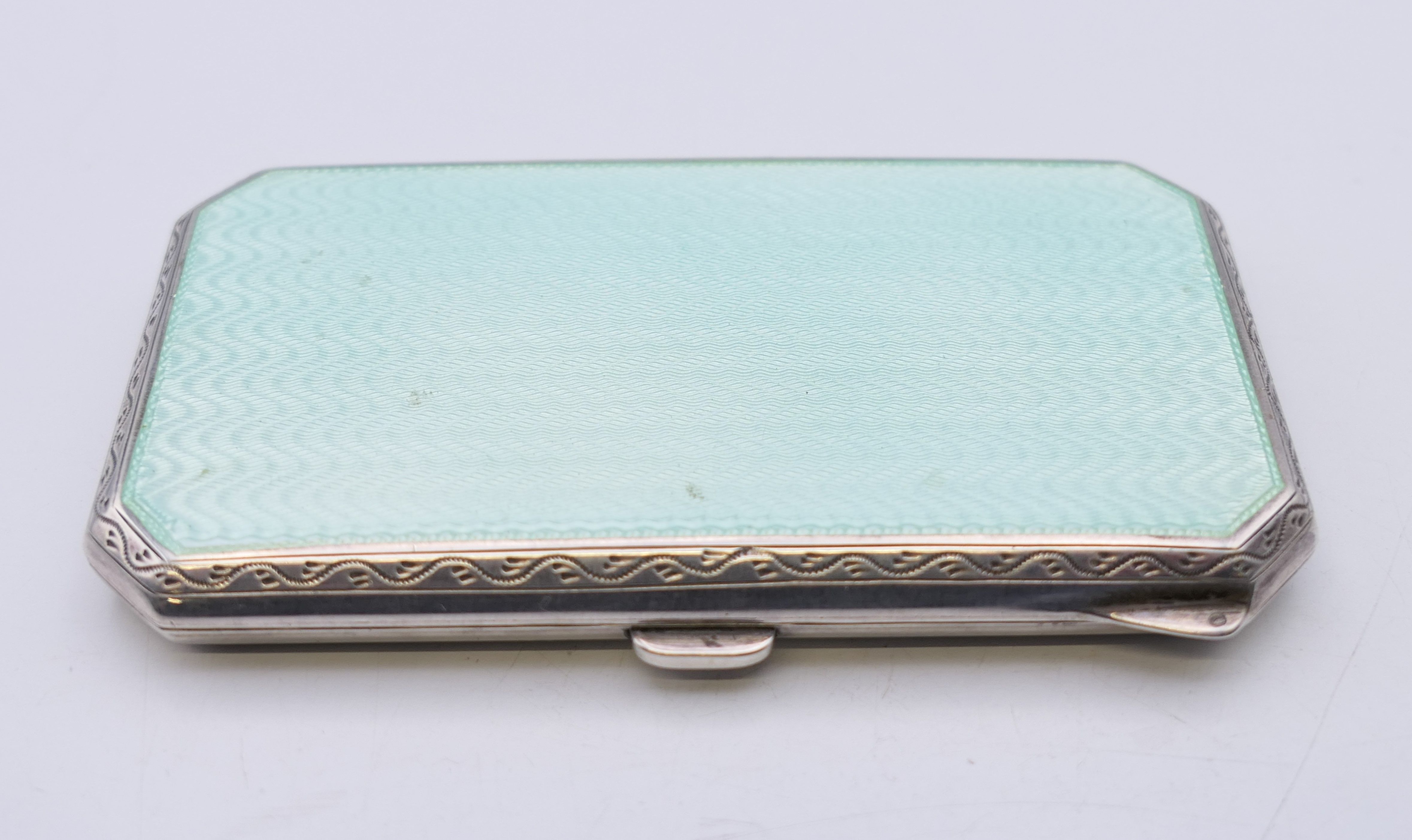 An early 20th century enamel decorated silver cigarette case. 8 cm x 4.5 cm.