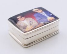 A silver Two Ronnies pill box. 3.25 cm x 2.5 cm.